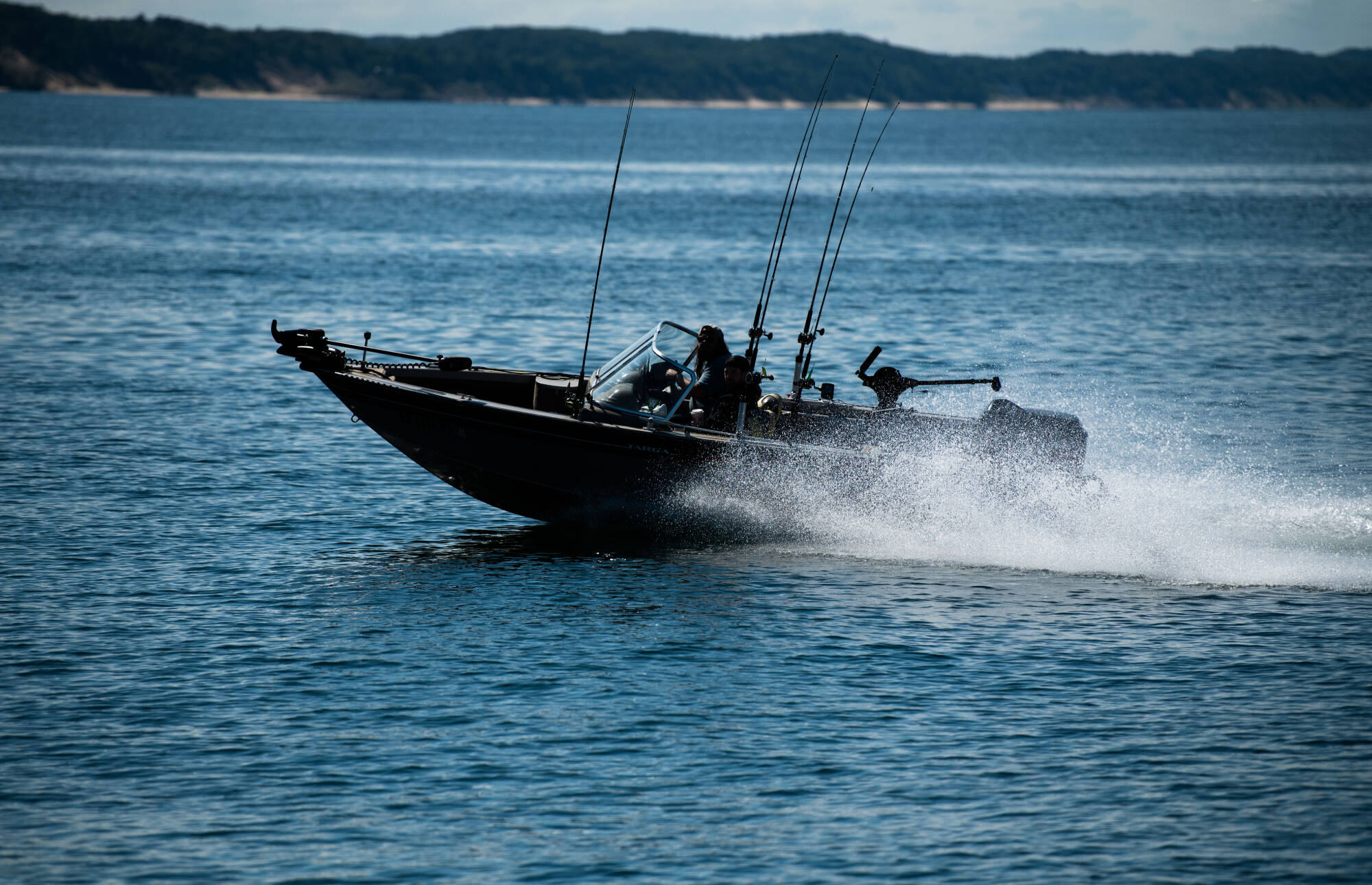 A fishing boat sets off loaded with gear on Muskegon Lake.